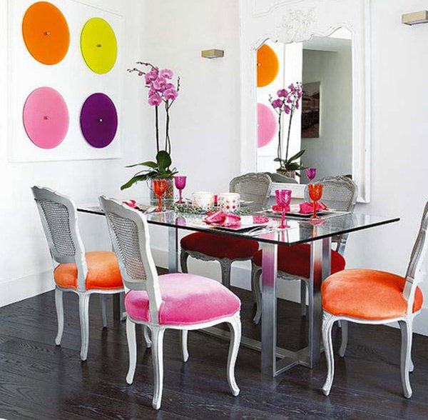 glass table with multi colored chairs