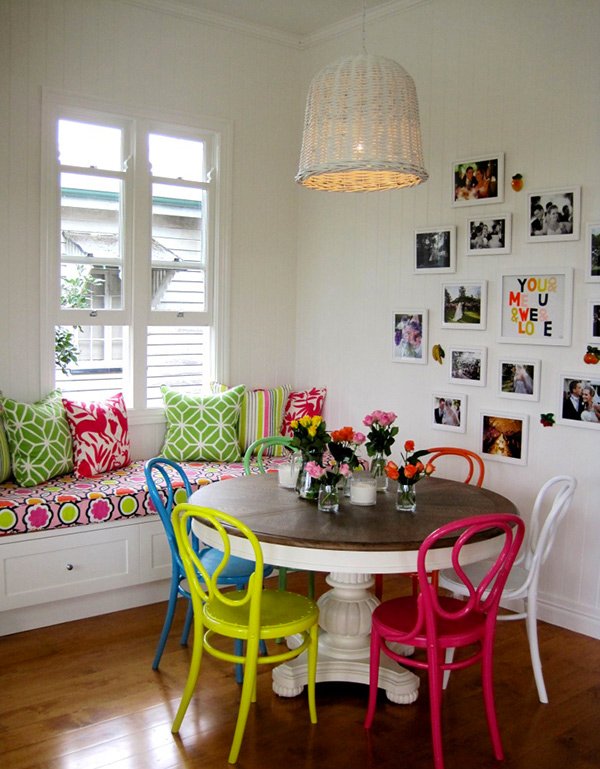 white dining table with multi coloured chairs