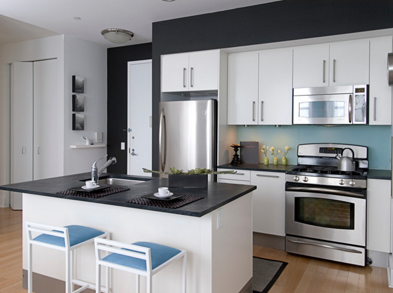 modern white kitchen cabinets with black countertops